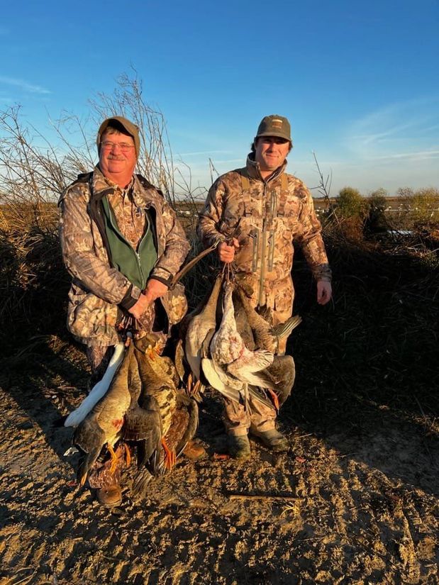 Hunters in a flooded South Louisiana rice field at sunrise
